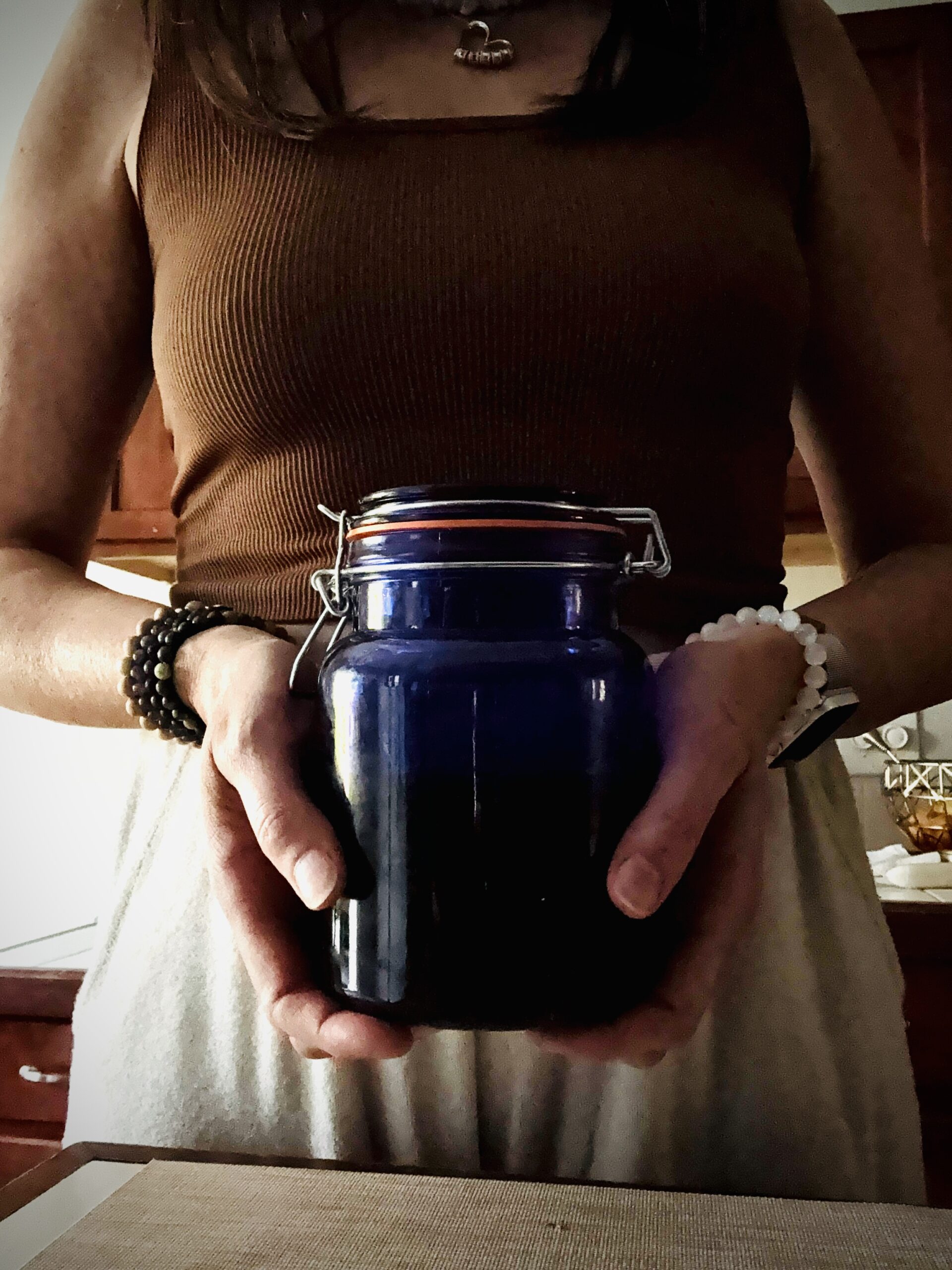 Hands holding a blue jar - The Practice
